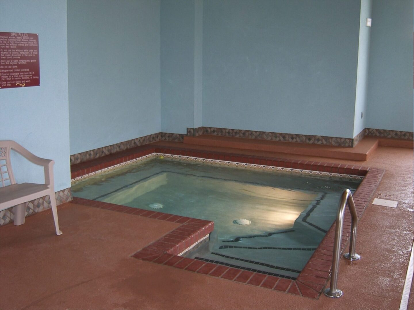 Small swimming pool area with sitting sections