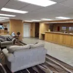 The lobby of a parkfield motel with couches and chairs.