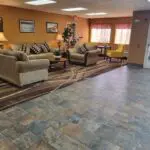 The lobby of a motel with couches and chairs, located in Parkfield.