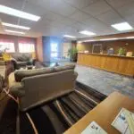 The lobby of a hotel adorned with comfortable couches and a sleek reception area.