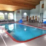 A parkfield hotel with a swimming pool inside the building.