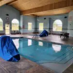 A parkfield hotel with an indoor swimming pool covered in blue.