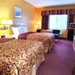 A parkfield hotel room with two beds and a television.